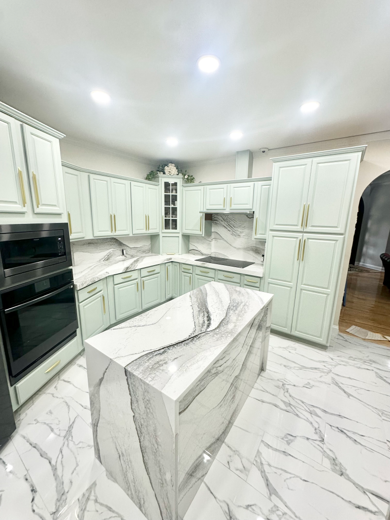 | Atlanta Granite Pros White and gray mitered quartz kitchen countertops with a matching full-height backsplash and mint shaker cabinets in Snellville by Atlanta Granite Pros.