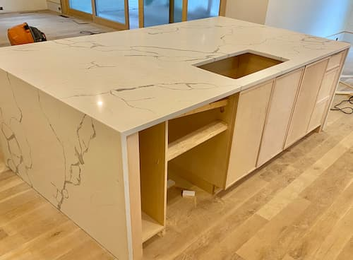 quartz-countertops-Loganville-GA | Atlanta Granite Pros Quartz countertops installation Loganville GA kitchen island features quartz with veins. Engineered quartz provided by Atlanta Granite Pros